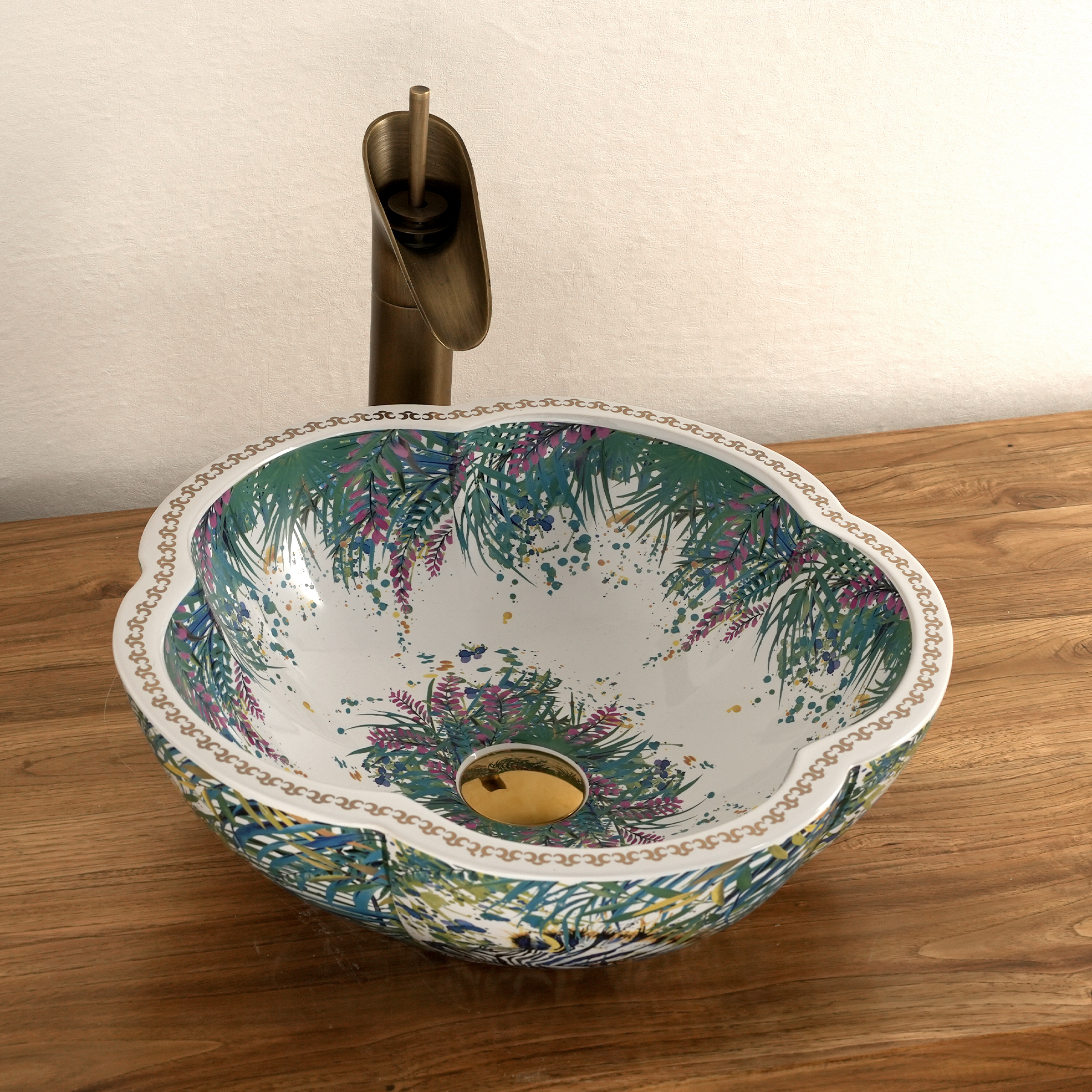 Ceramic washbasin with a green and white floral print