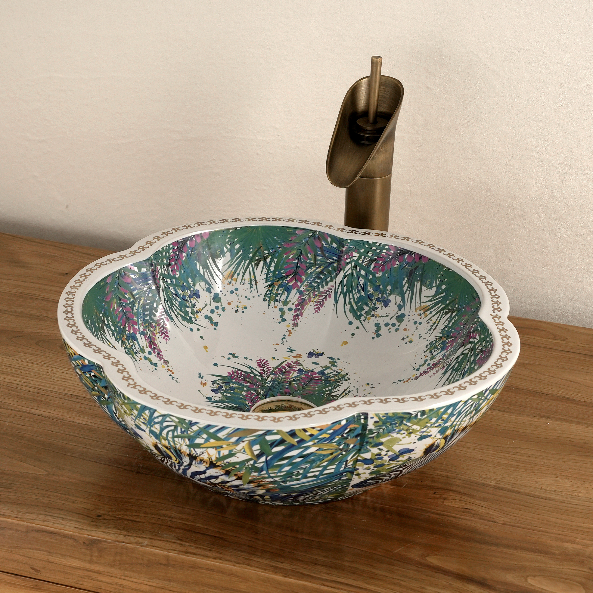 Ceramic washbasin with a green and white floral print