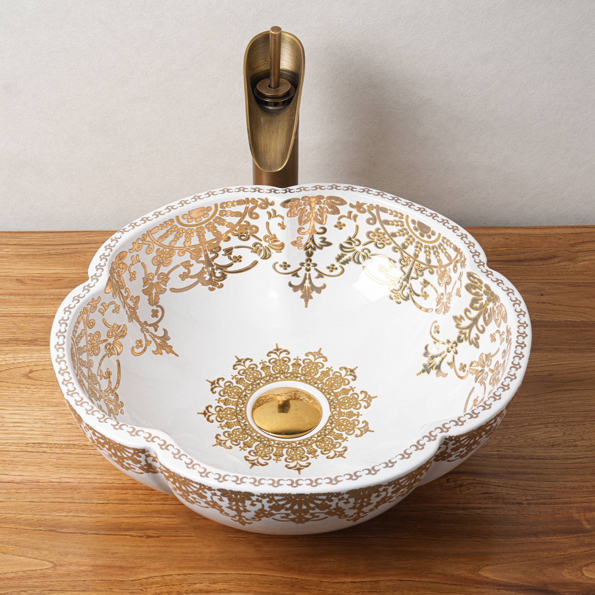 Ceramic washbasin with gold and white floral print