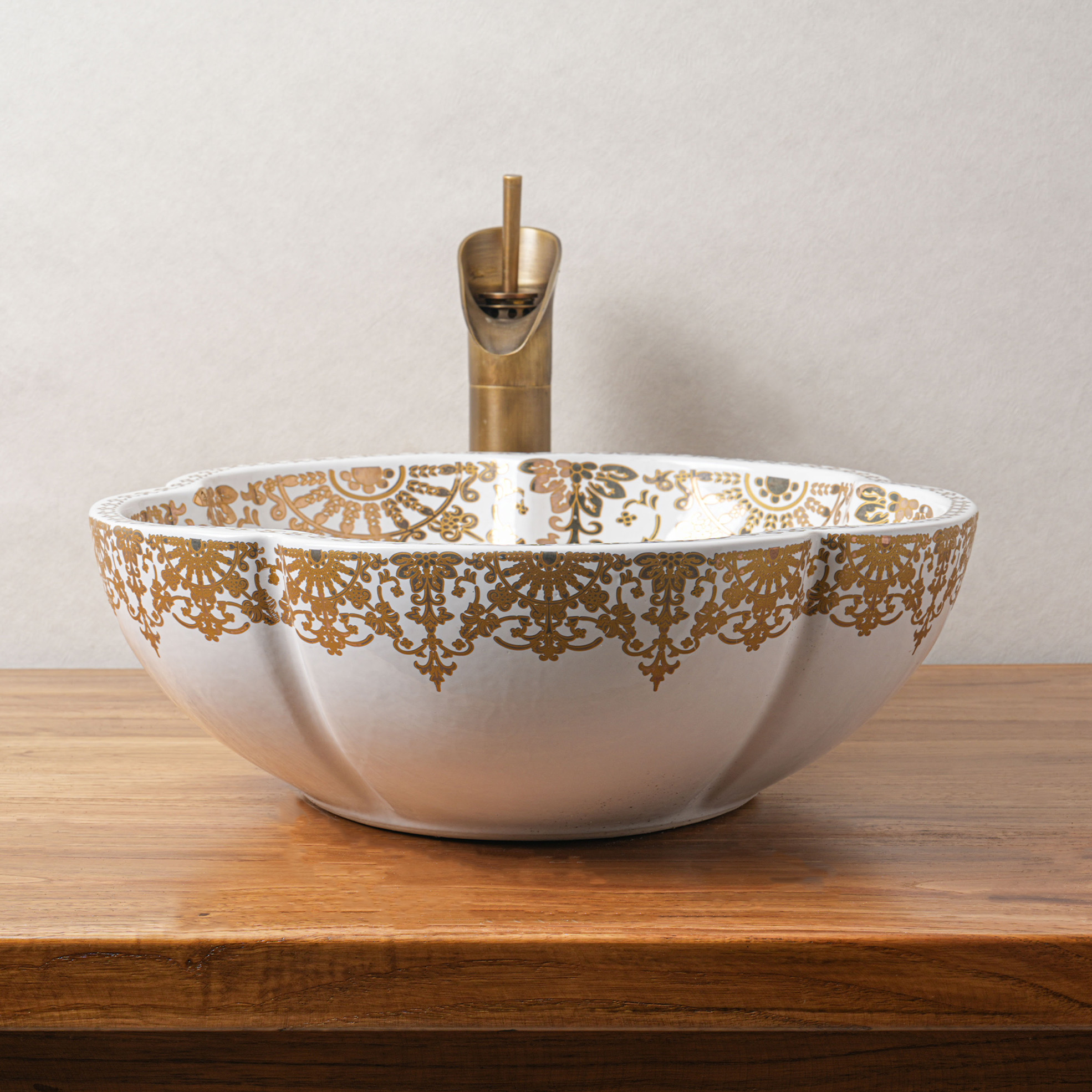 Ceramic washbasin with gold and white floral print