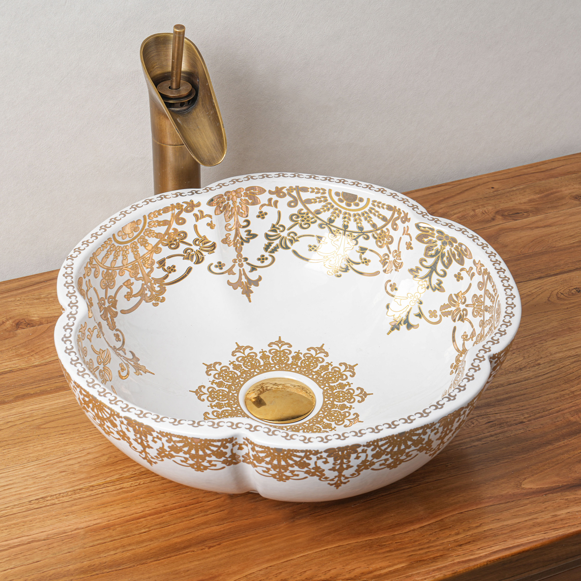 Ceramic washbasin with gold and white floral print