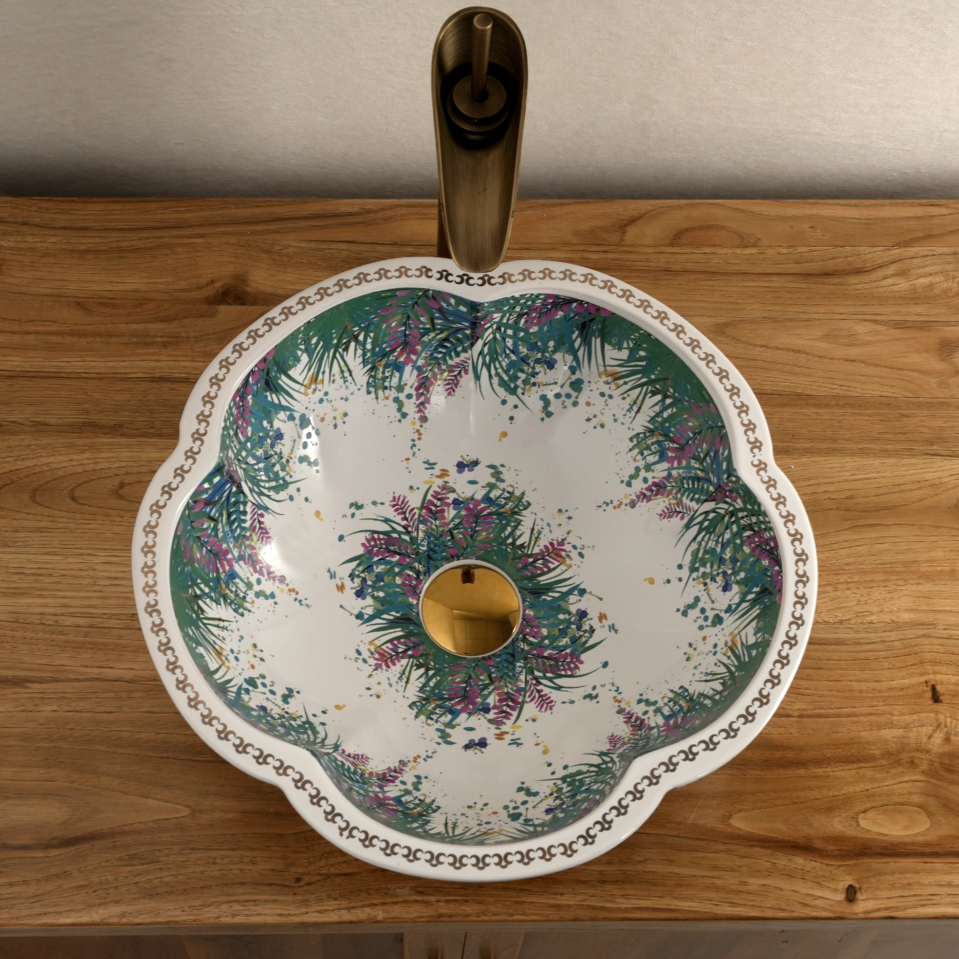 Ceramic washbasin with a green and white floral print