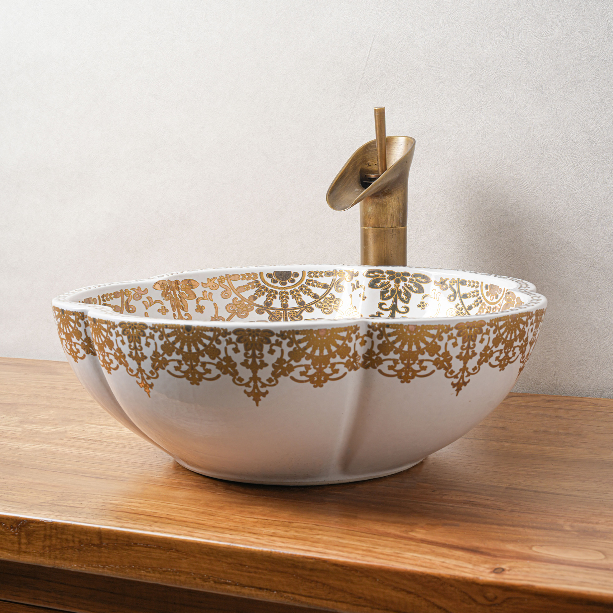 Ceramic washbasin with gold and white floral print