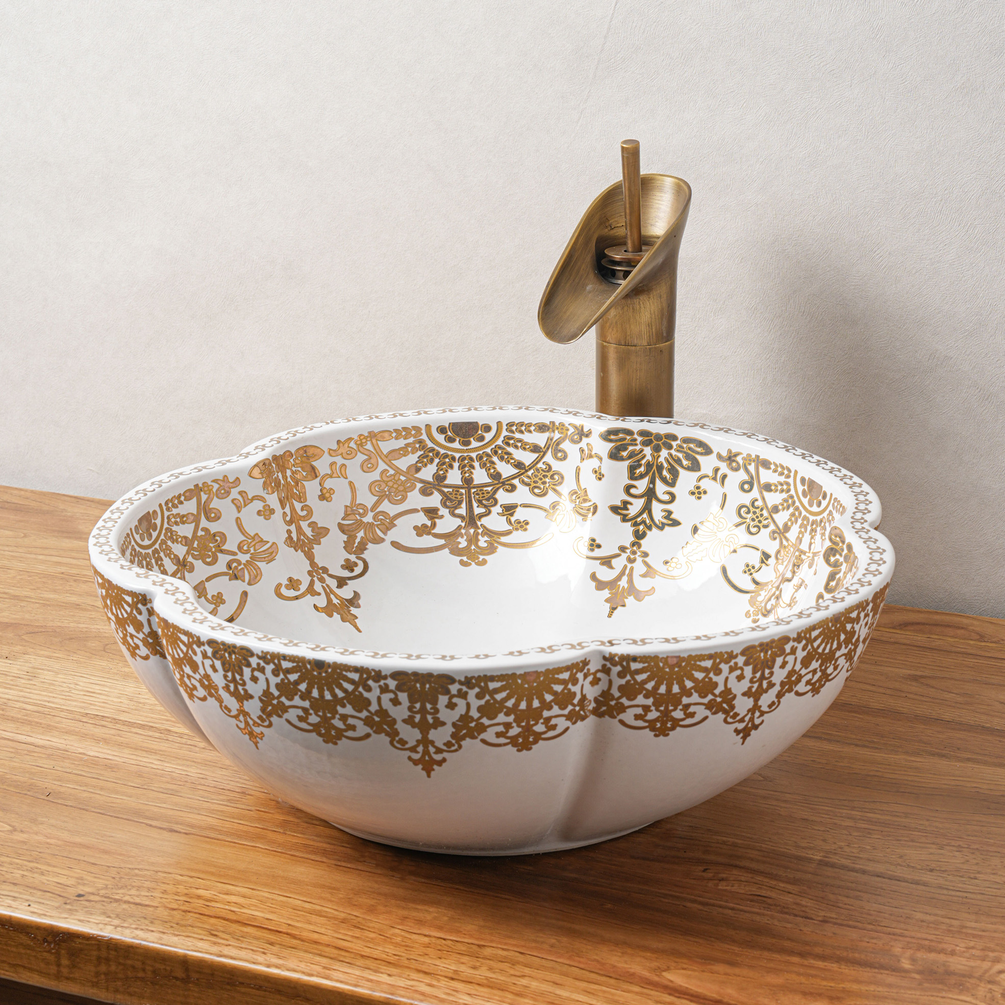 Ceramic washbasin with gold and white floral print