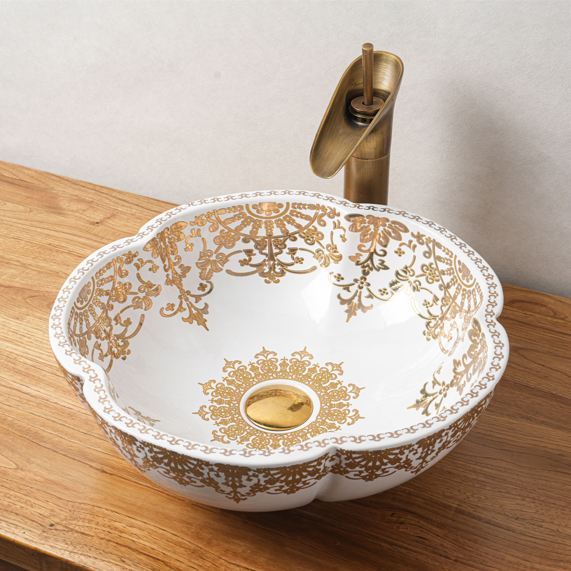Ceramic washbasin with gold and white floral print