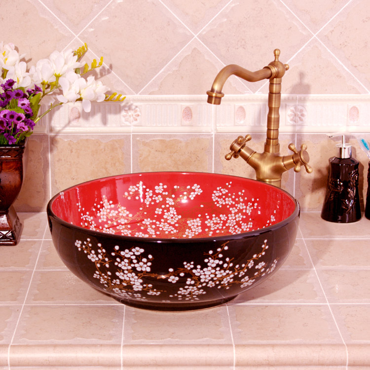 Washbasin with a red and black floral pattern