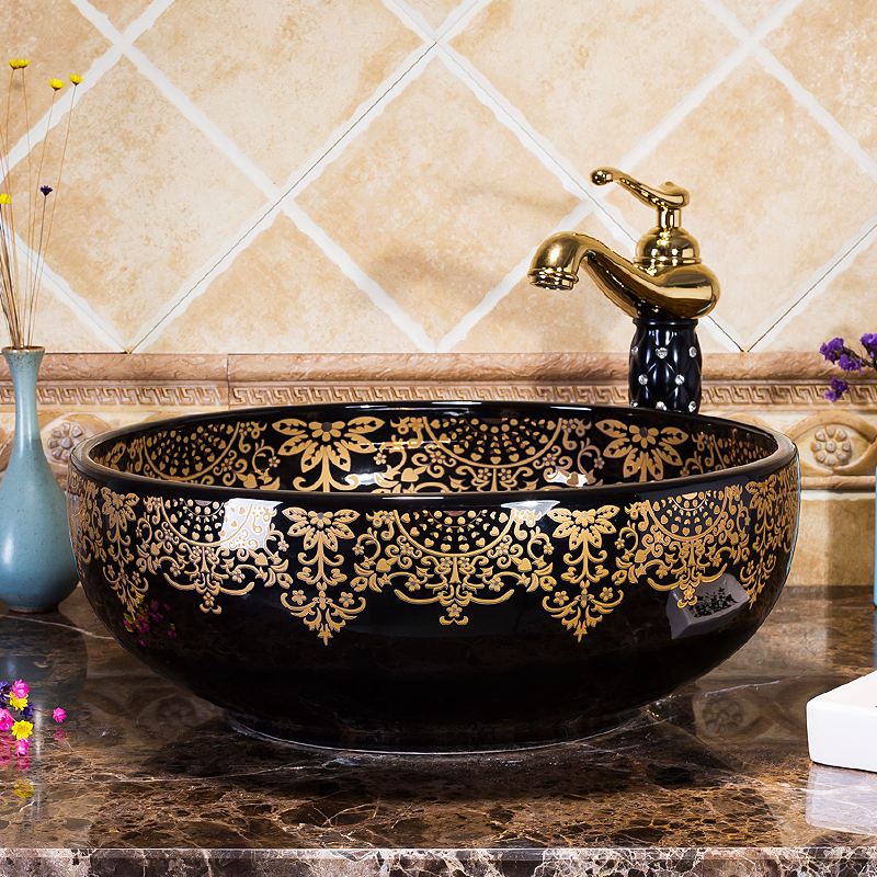 Black washbasin with gold patterns