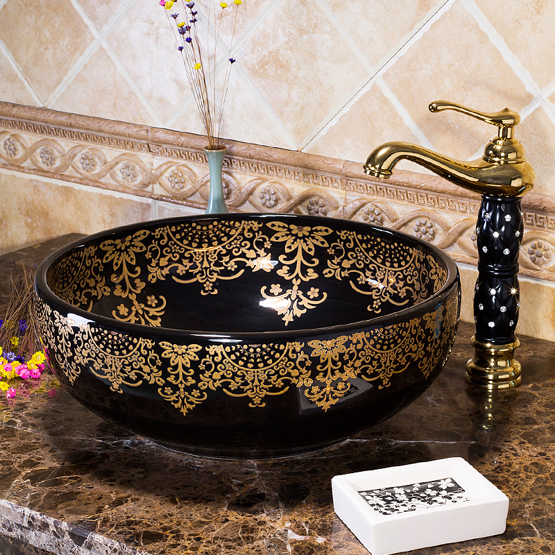 Black washbasin with gold patterns