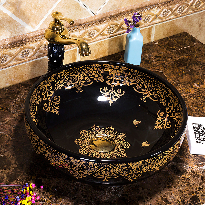 Black washbasin with gold patterns