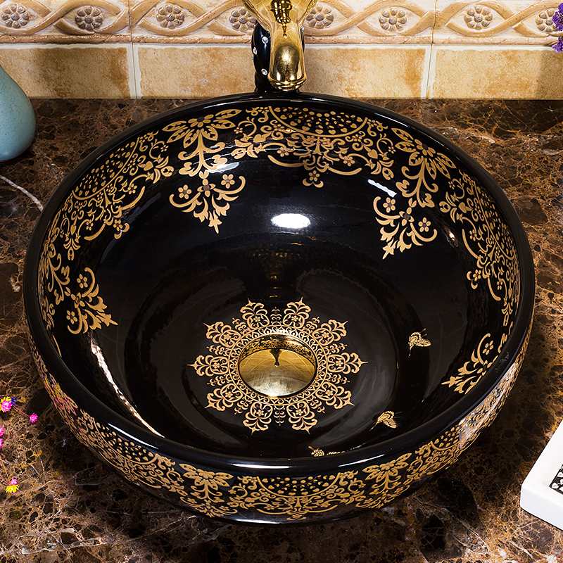 Black washbasin with gold patterns