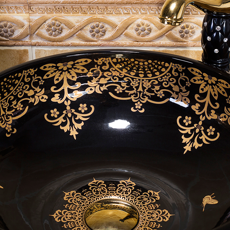 Black washbasin with gold patterns