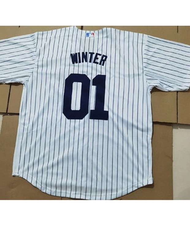 Customer photo of a pinstriped baseball jersey with a name and number laid on a bed