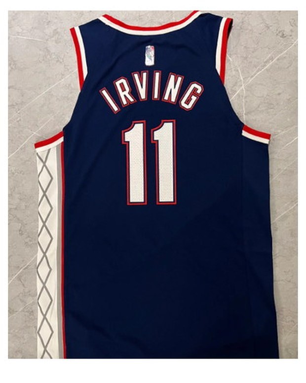 Customer photo of a navy basketball road jersey with number 11 laid flat