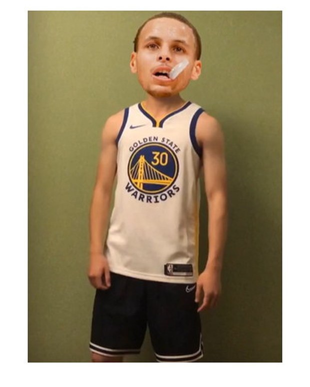 Customer photo of a child wearing a blue and gold youth basketball jersey with matching shorts