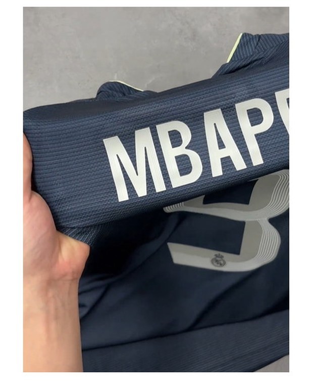 Customer photo of a navy football shirt with a printed name and number set across the back