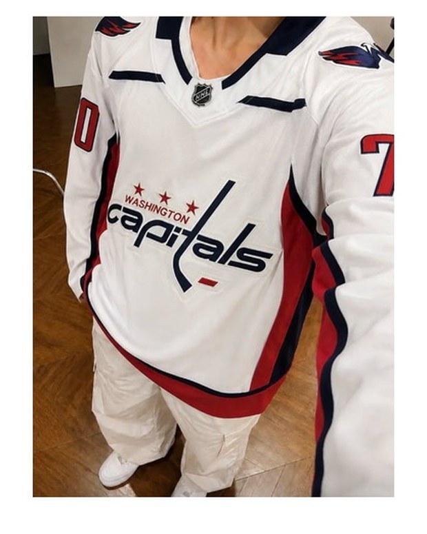 Customer photo of a white hockey away jersey with the full crest worn over jeans