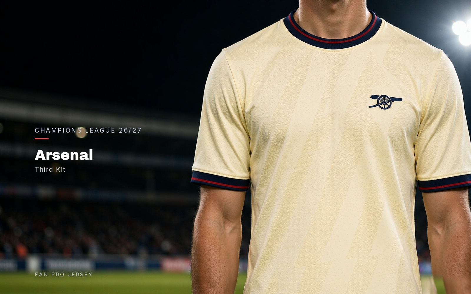Arsenal 2026/27 third kit — pale cream football shirt with navy and red trim, worn torso close-up under stadium lights