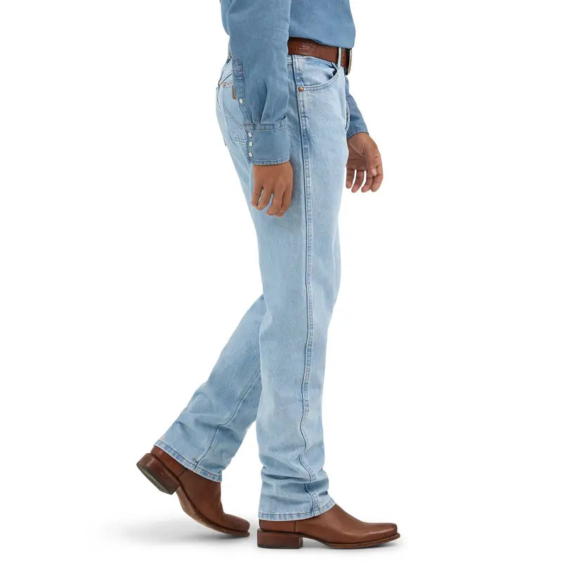 Side view of men's straight-leg western jeans worn over cowboy boots