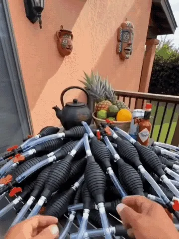 Manual siphon pump transferring liquids in several everyday settings