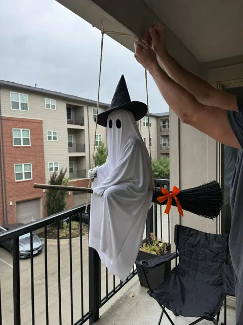 Flying broom ghost being installed on an apartment balcony