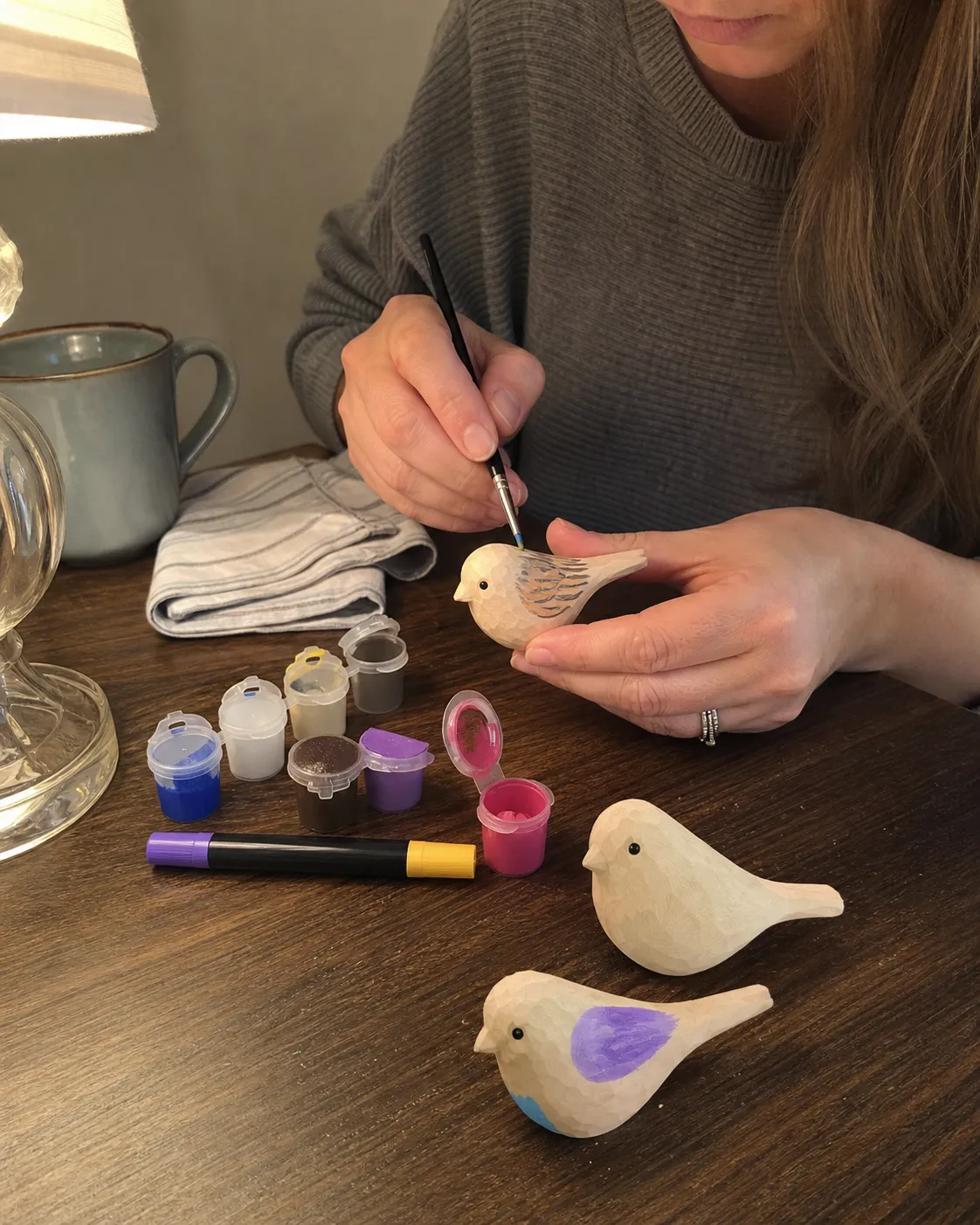 Customer enjoying an evening wooden bird painting project