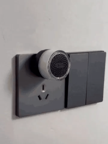 Wireless doorbell button being mounted and pressed while the indoor plug-in chime lights up