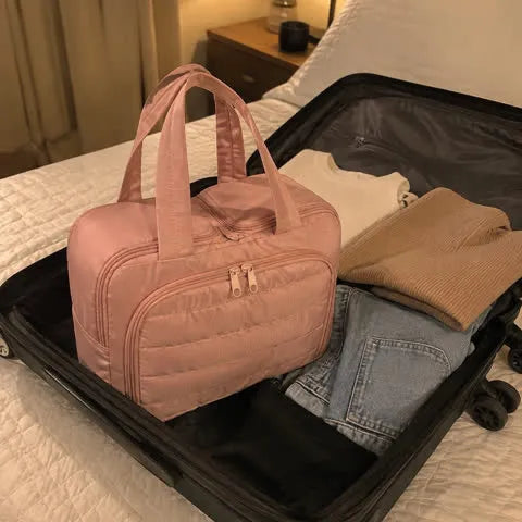 Pink organizer packed in a carry-on suitcase