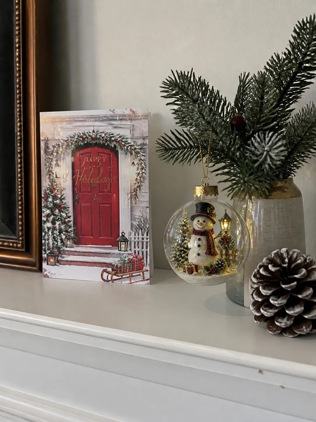 Snowman ornament displayed on a bright mantel