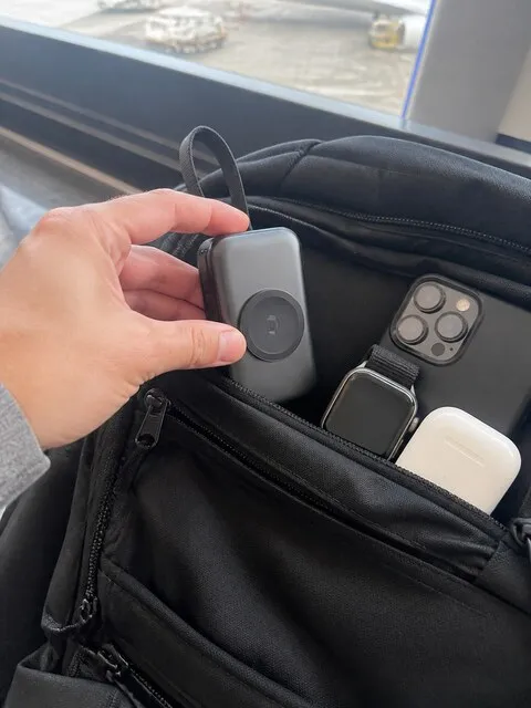 Portable 3-in-1 charger packed beside travel essentials at the airport