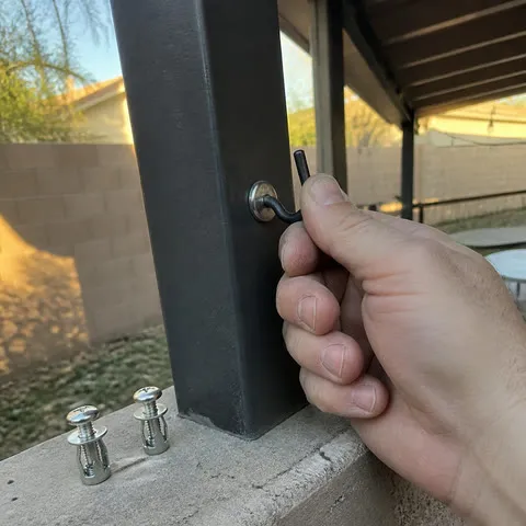 Checking a small hook mounted to a hollow patio post