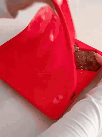 Silicone mold being filled, covered, frozen, and used for burger patties