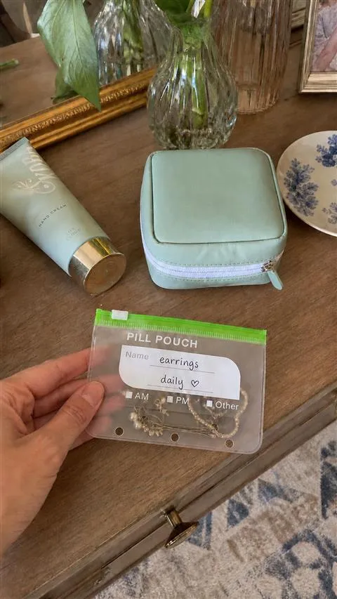 Removable pouch holding small jewelry beside the closed case