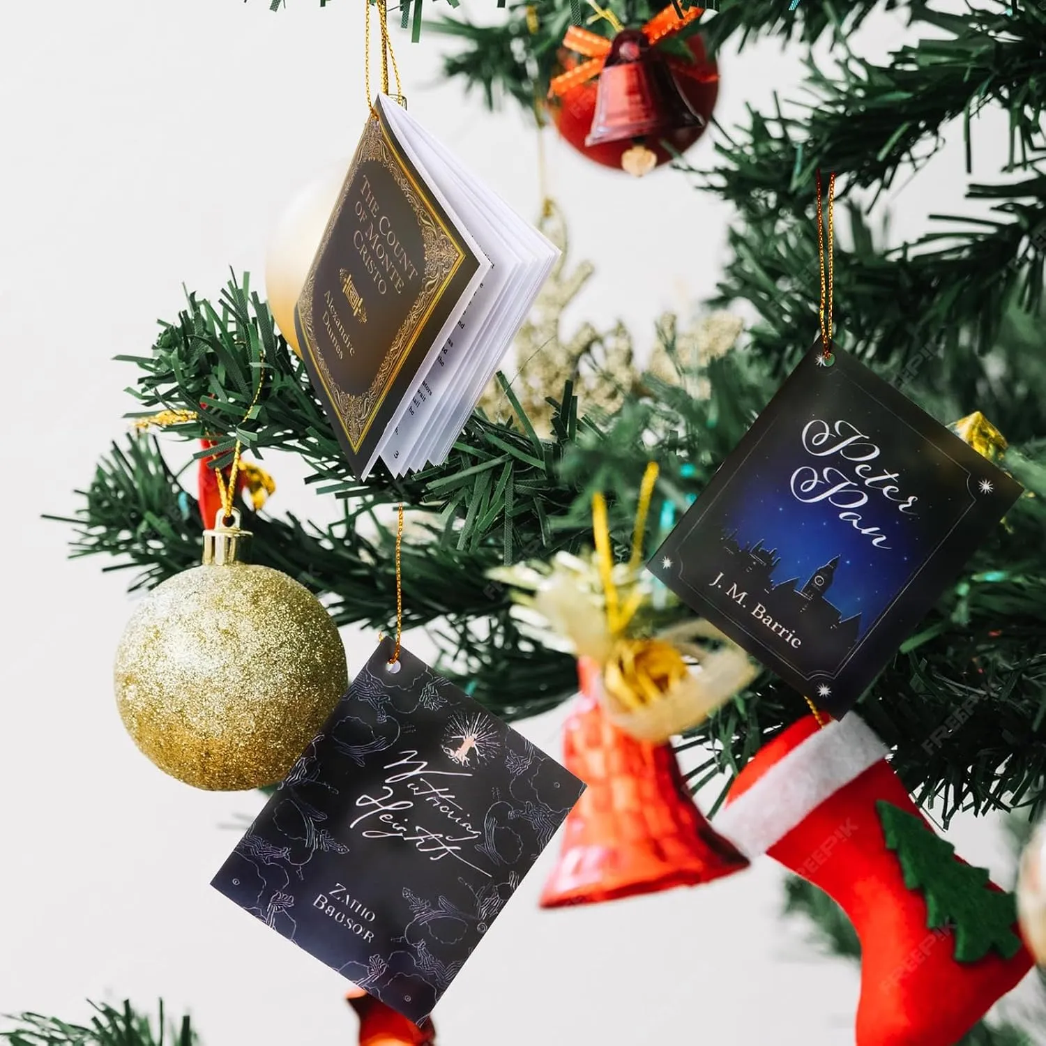 Miniature book ornaments hanging from a Christmas tree