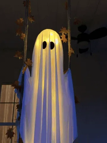 Light-up swinging ghost moving on a decorated porch