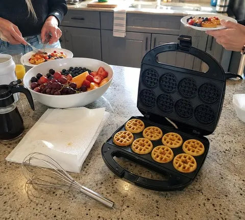 Friends serving a batch of mini waffles at brunch