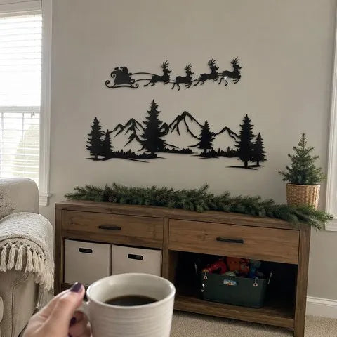 Two-piece black metal Christmas wall art displayed above a family-room sideboard