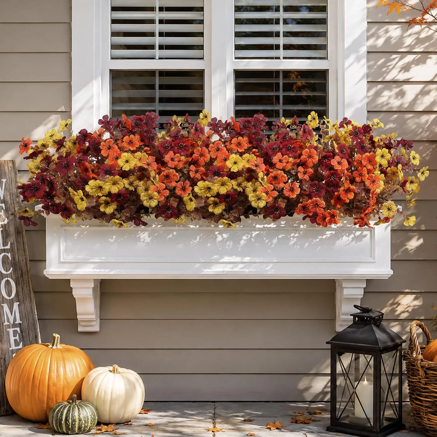 Artificial fall flowers filling a sunny window box