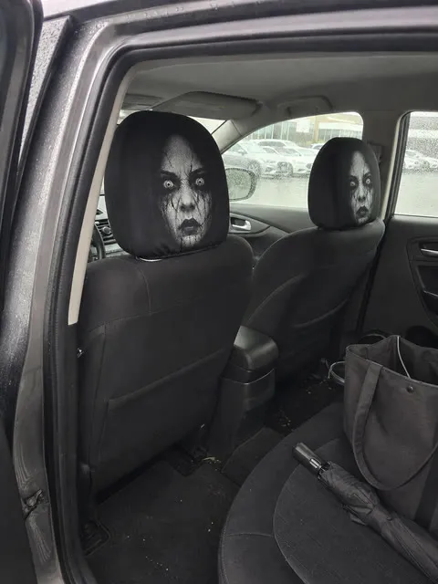 Casual rainy office parking lot reaction to scary car headrest covers