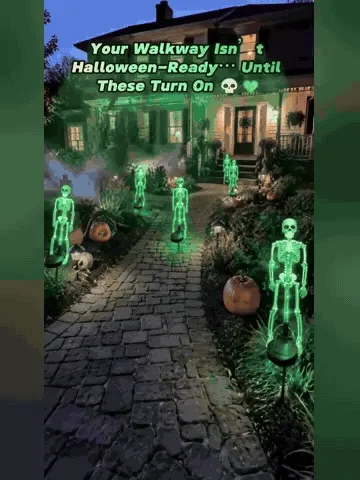 Solar skeleton yard stake glowing at night