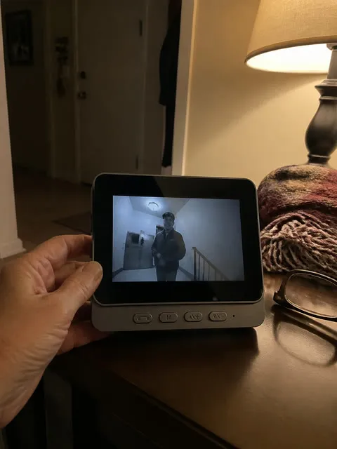 Indoor monitor displaying a nighttime hallway visitor