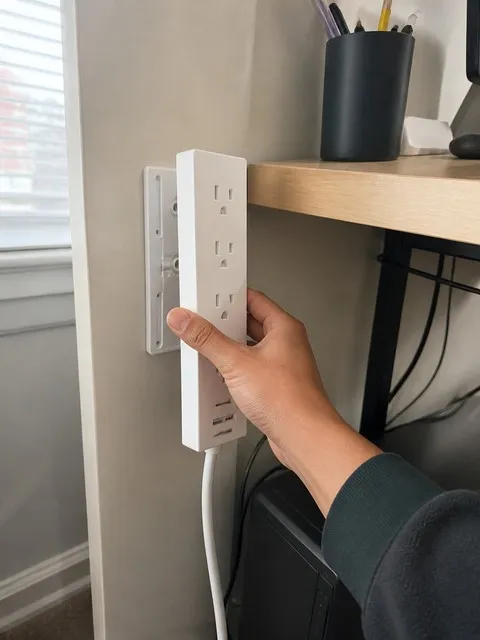 Mounted power strip beside a home office desk