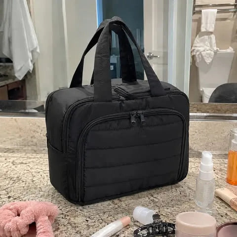 Black organizer in use on a hotel vanity