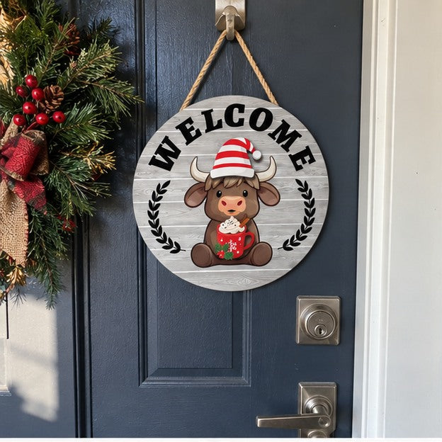 Snowy Gray Highland cow welcome sign on an apartment entry door