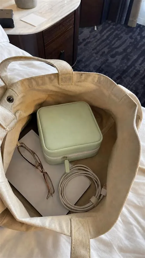 Closed organizer packed inside a canvas travel tote