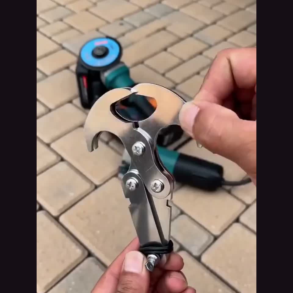 Hands unfolding the four-claw retrieval hook