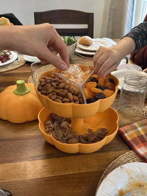 Orange pumpkin snack server during a family fall gathering