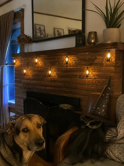 Bat string lights displayed over a brick fireplace mantel