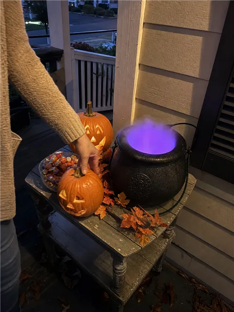 Casual customer porch display with a glowing cauldron