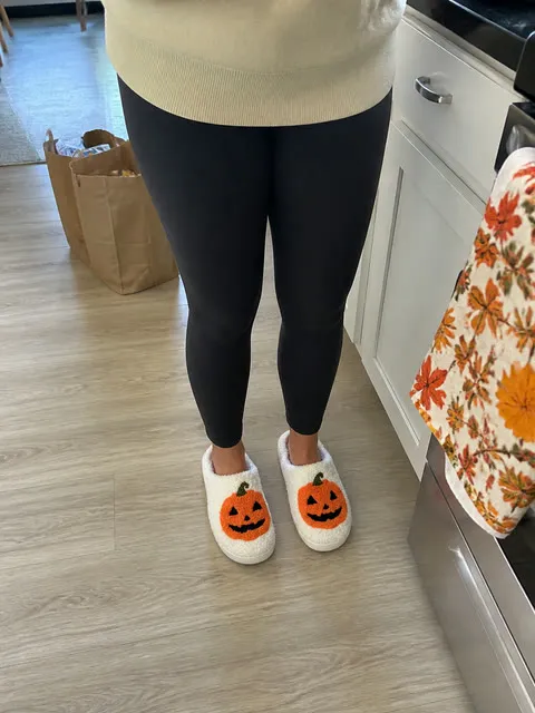 White pumpkin slippers worn in a bright kitchen