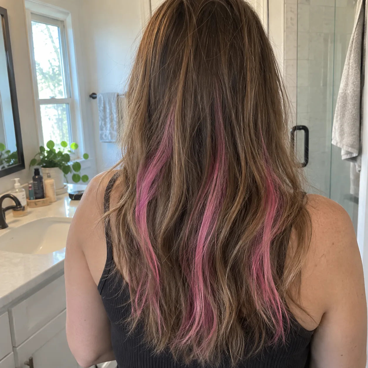 Pink hair chalk streaks applied at home